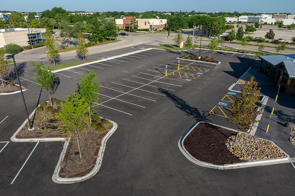 Drone image above parking lot renovated by Corebuilt Contracting with landscape plan and green grass in Gurnee Illinois